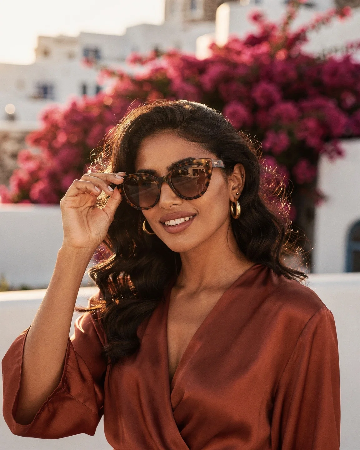 Woman in tortoiseshell cat-eye sunglasses on a terrace